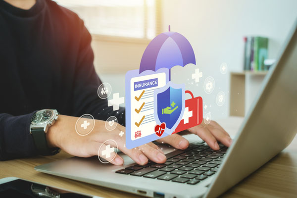 hands on a notebook computer with a graphic depicting business insurance above it